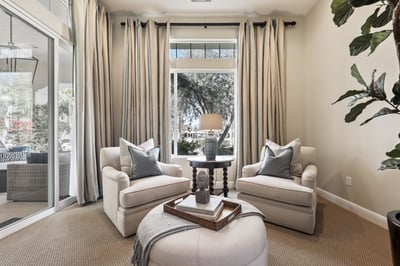 Primary bedroom seating area with patio access