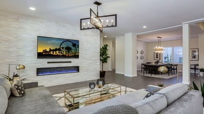 Newly remodeled living room with stacked stone media wall, modern furnishings and fireplace and open