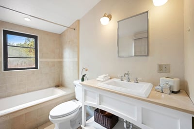 Unwind in your private bathroom with classic fixtures, soft lighting, and fresh towels. A soaking tu
