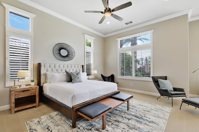 Primary bedroom with California king. Smart TV, walk-in closet, and en suite bathroom.