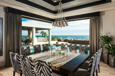 The dining area features a uniquely designed chandelier as well as 12 zebra print chairs for the lar