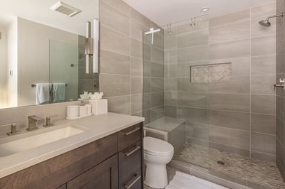 Step into your spa-like bathroom retreat with sleek gray tiles, spacious walk-in shower, and modern 