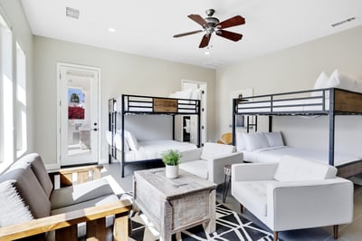 Casita living room space- Features 2 queen bunk beds, sitting area, Smart TV, and kitchenette.