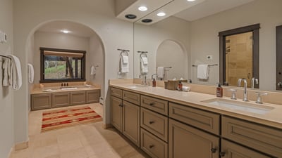 King ensuite with soaking tub, shower, and dual vanities
