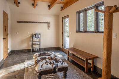 Your mudroom welcomes you with rustic charm and practical elegance. Store your gear on handcrafted w