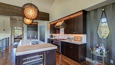 Gourmet kitchen features professional appliances, a large island with seating and wine refrigerator