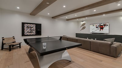 Family room on lower level with ping pong, wall scrabble, and TV