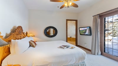 Main level king suite with patio access and TV