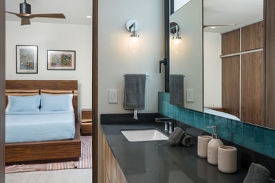 - Freshen up in a stylish bathroom just steps away from your plush bedroom bed
- Sleek vanity with d