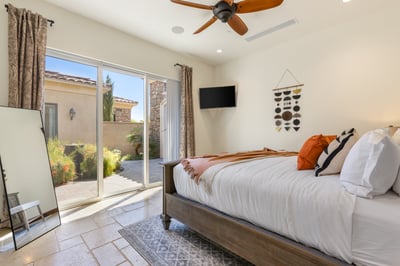 Guest bedroom 2 with front courtyard access. Shares full bath with rooms 3 & 4