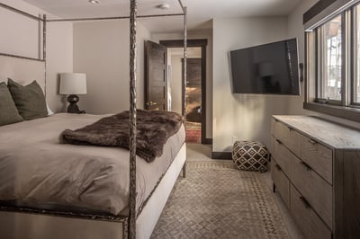 Unwind in your luxurious canopy bed with plush fur throw and modern amenities for the perfect mounta