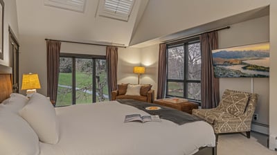 Primary king suite on upper (5th) level with TV and reading sofa
