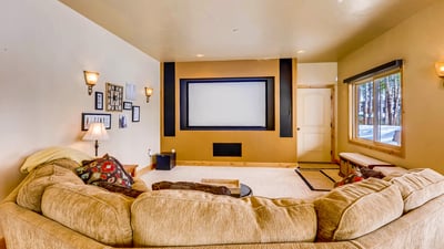 Large projection TV and comfortable sectional on lower level