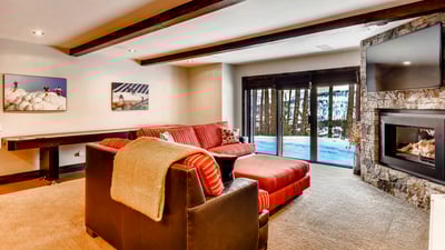Lower level family room with cozy seating around the fireplace