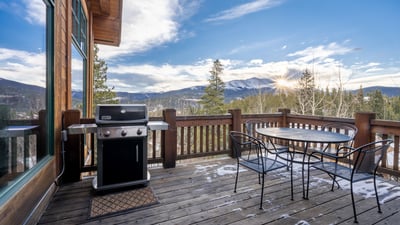 Deck off kitchen with grill, seating and views