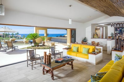 Wide floor-to-ceiling windows allow for a seamless transition from the outdoors to the indoor living