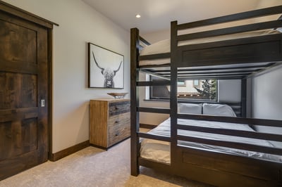 Bunk room with a queen-over-queen bunkbed, uses hall bathroom, lower level