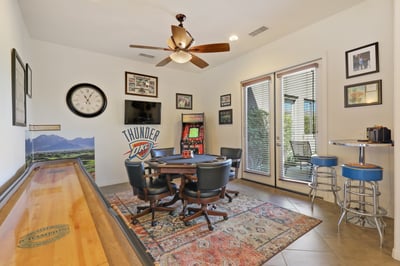 Ultimate game room with poker table, shuffle board and arcade game.