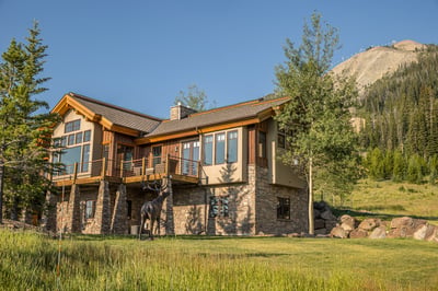 A striking mountain lodge with stone and wood.