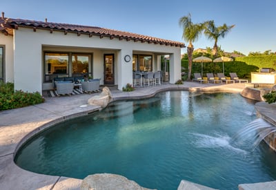 Large pool with tanning shelf and calming waterfalls