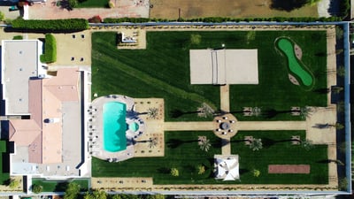 Expansive One Acre Lot with resort-style amenities: large pool/spa, sand volleyball, putting green, 