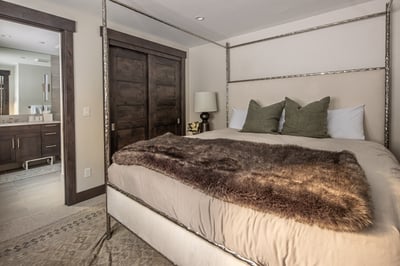 Sink into luxurious comfort with plush linens, rich textures, and an elegant four-poster bed that pr