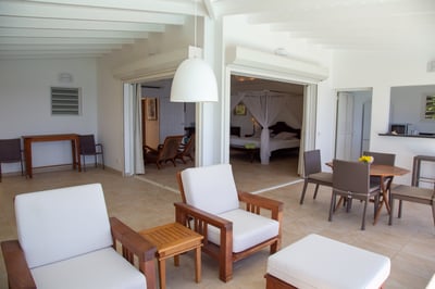 Living & Dining Area: Covered lounge/dining room area on the open terrace facing the pool and overlo