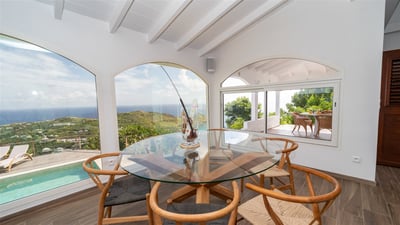Dining Areas: Inside and outside dining tables with six wooden chairs.