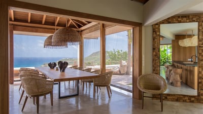 Dining Area: Large wooden table for 10 guests on the covered terrace. 