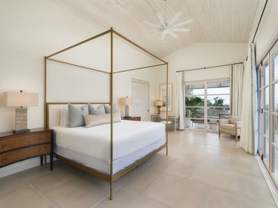 - Sleep peacefully in this cozy canopy bed framed by soft tones and warm wood
- Step outside through