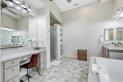 Primary bathroom. Dual sinks and an additional vanity, stand alone shower, and jetted tub.