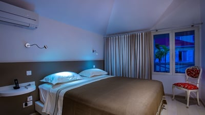 Bedroom 1: View on the street of downtown Gustavia. King size bed, air conditioning, telephone, safe