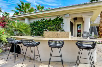 Outdoor kitchen with sink and BBQ. Seating for 4.