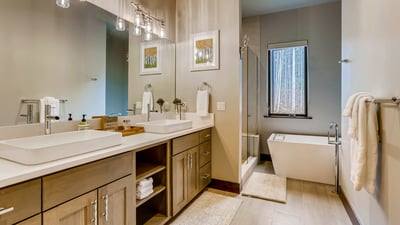 Primary ensuite with dual vanity, soaking tub and walk-in shower