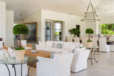 - Elegant sofas and earthy textures pair with greenery and clean modern tones
- Relax under airy vau
