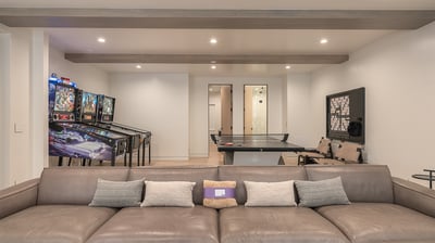 Family room on lower level with ping pong, wall scrabble, and pinball machines