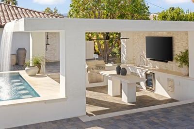 Swim up bar and outdoor kitchen including grill, wine fridge, sink and large screen TV.