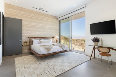 Guest bedroom 4 with king bed, en suite bath and direct access to balcony overlooking the pool