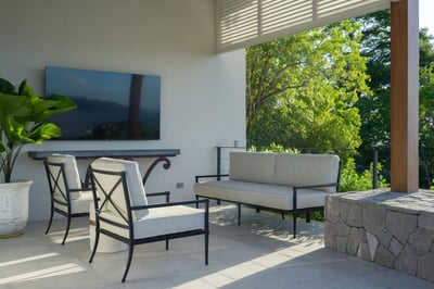 - Lounge under shade with cushioned chairs and lush views of the treetops
- Watch a movie or game ou