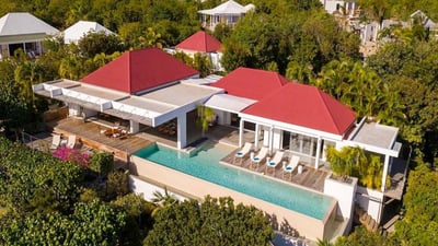 Outdoors: Lush and tropical garden surrounding the property. Private parking on the back of the prop