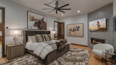 Primary king suite on main level with TV and fireplace