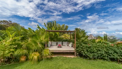 Outdoors: Beautiful landscaped garden of flamboyant trees, bougainvillea and palms envelops the prop