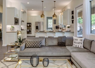Newly remodeled living room with stacked stone media wall, modern furnishings and fireplace and open