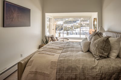 Drift off in your cozy alpine bedroom with stunning mountain views right from your pillow.
