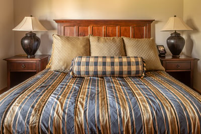 Sink into soft linens and plush pillows in your elegant bedroom, where classic wood furnishings.