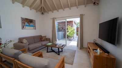 Living & Dining Area: Inside living area in the air-conditioned great room, with pool and ocean view