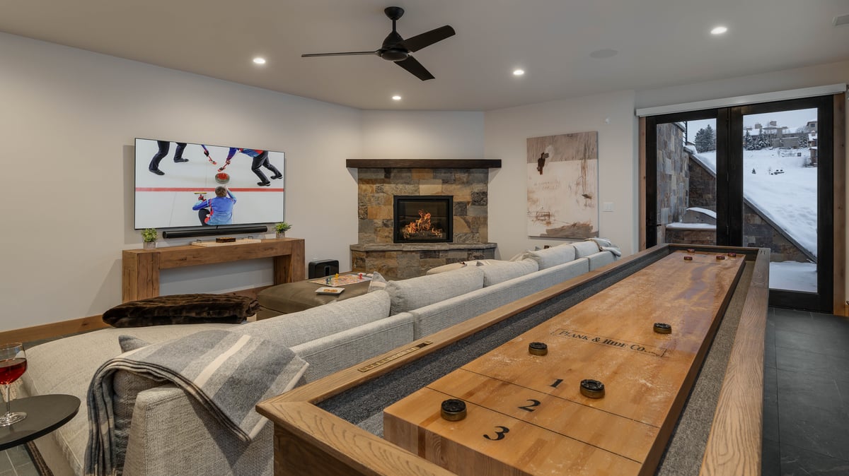 Downstairs family room with shuffleboard and fireplace - Image 8