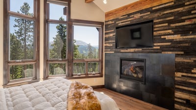 Primary suite on main level with fireplace, views