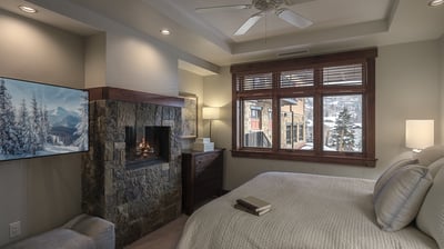 Primary bedroom suite with king bed and fireplace