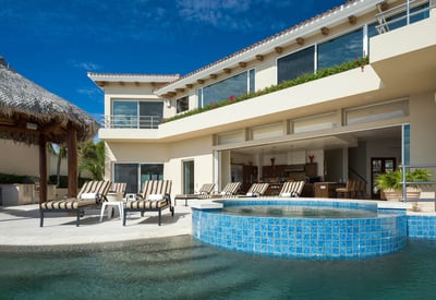 Relax and unwind on one of the many lounge chairs that look out over the terrace at Villa del Mar